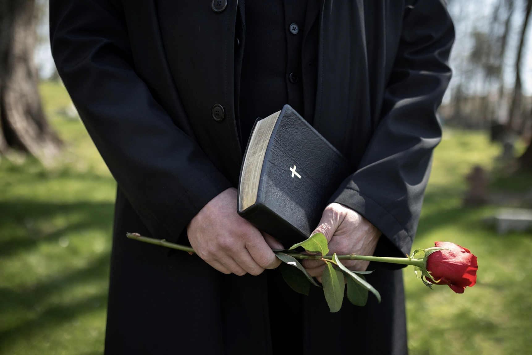 Мужчина стоит на похоронах