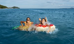 Девушки купаются в море.