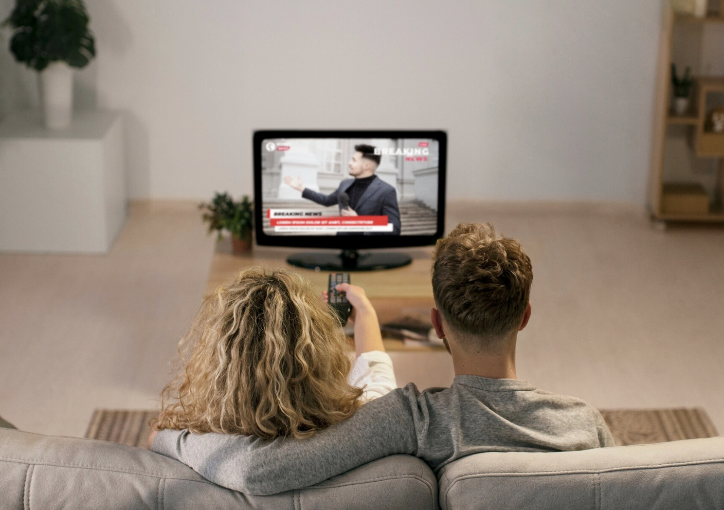 Молодая пара смотрит телевизор