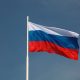 Флаг России на фоне голубого неба.
