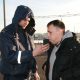 Инспектор ГИБДД проверяет водителя на уровень содержания алкоголя в крови с помощью алкотестера